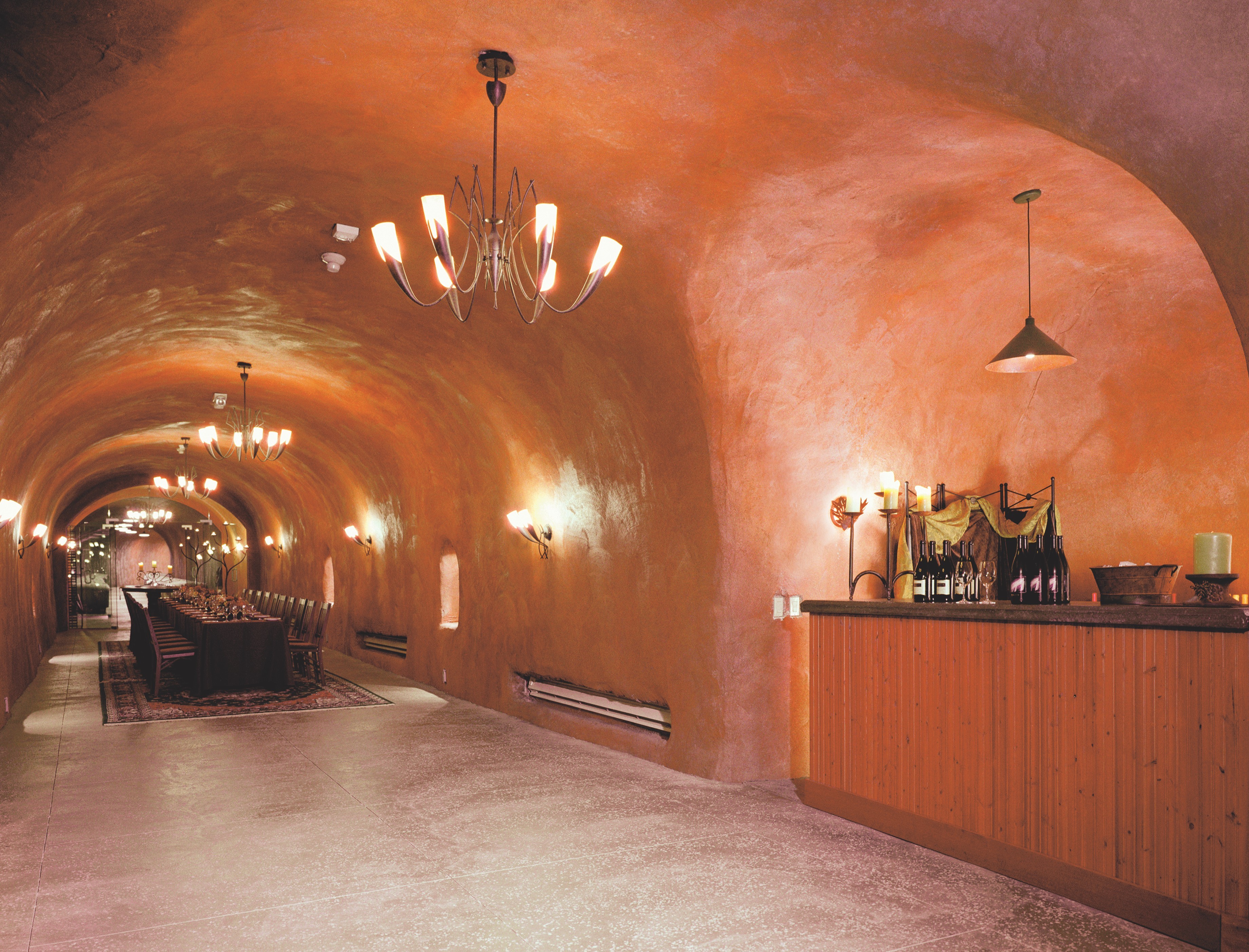 Long arched dining hall with warm plaster walls