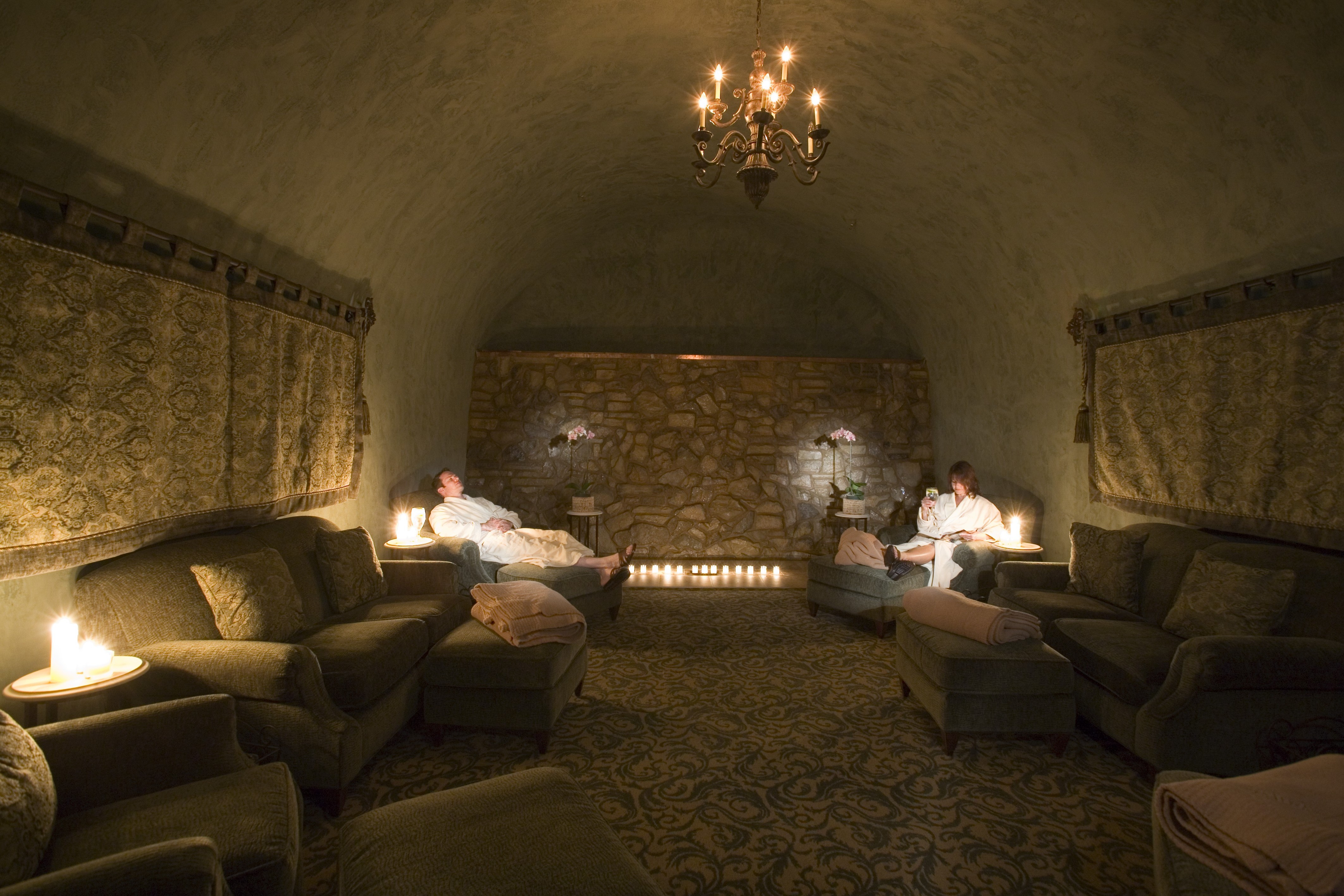 Candlelit parlor with stone walls