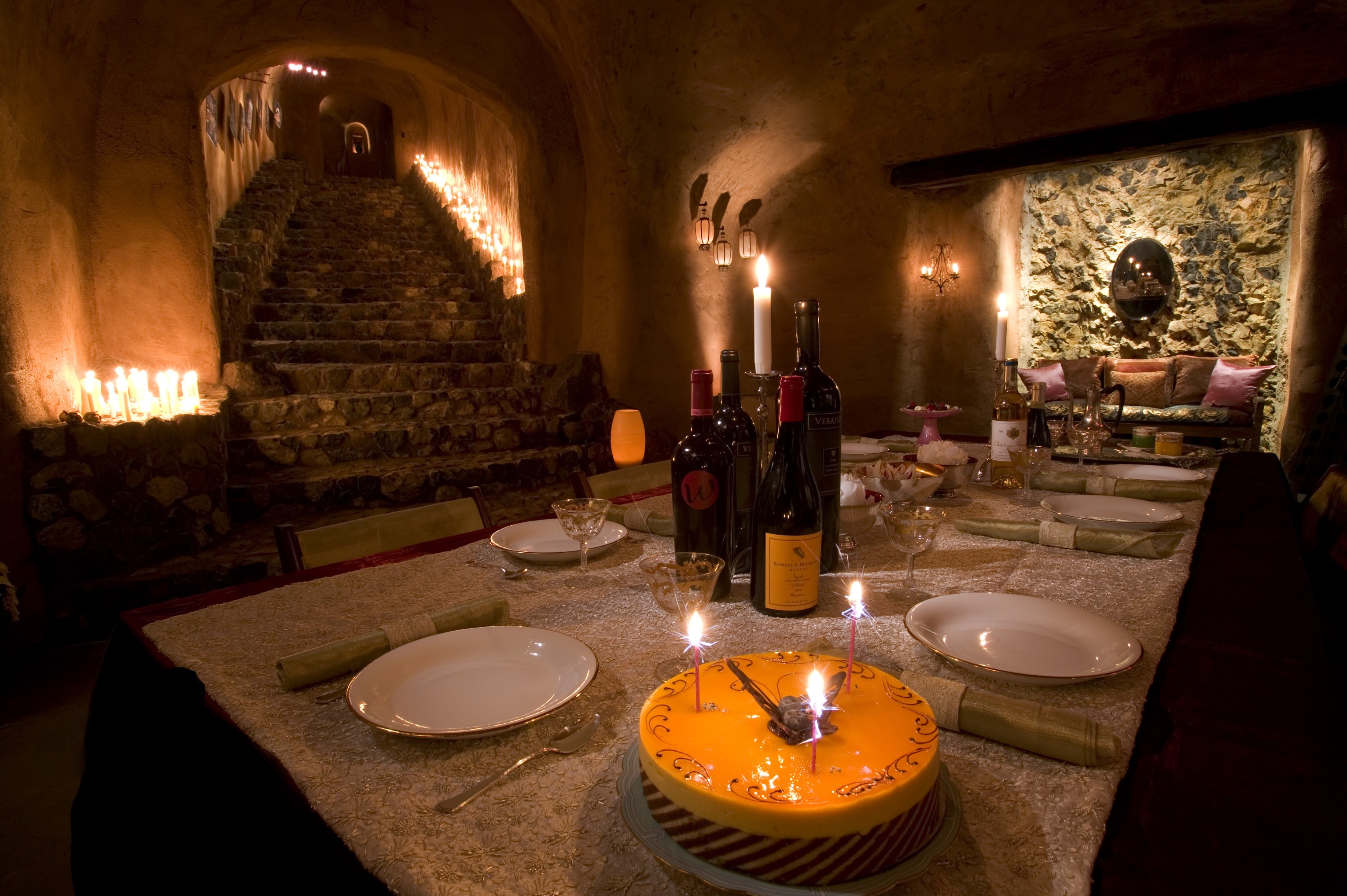 Stone stairway and dining room in a candlelit cave